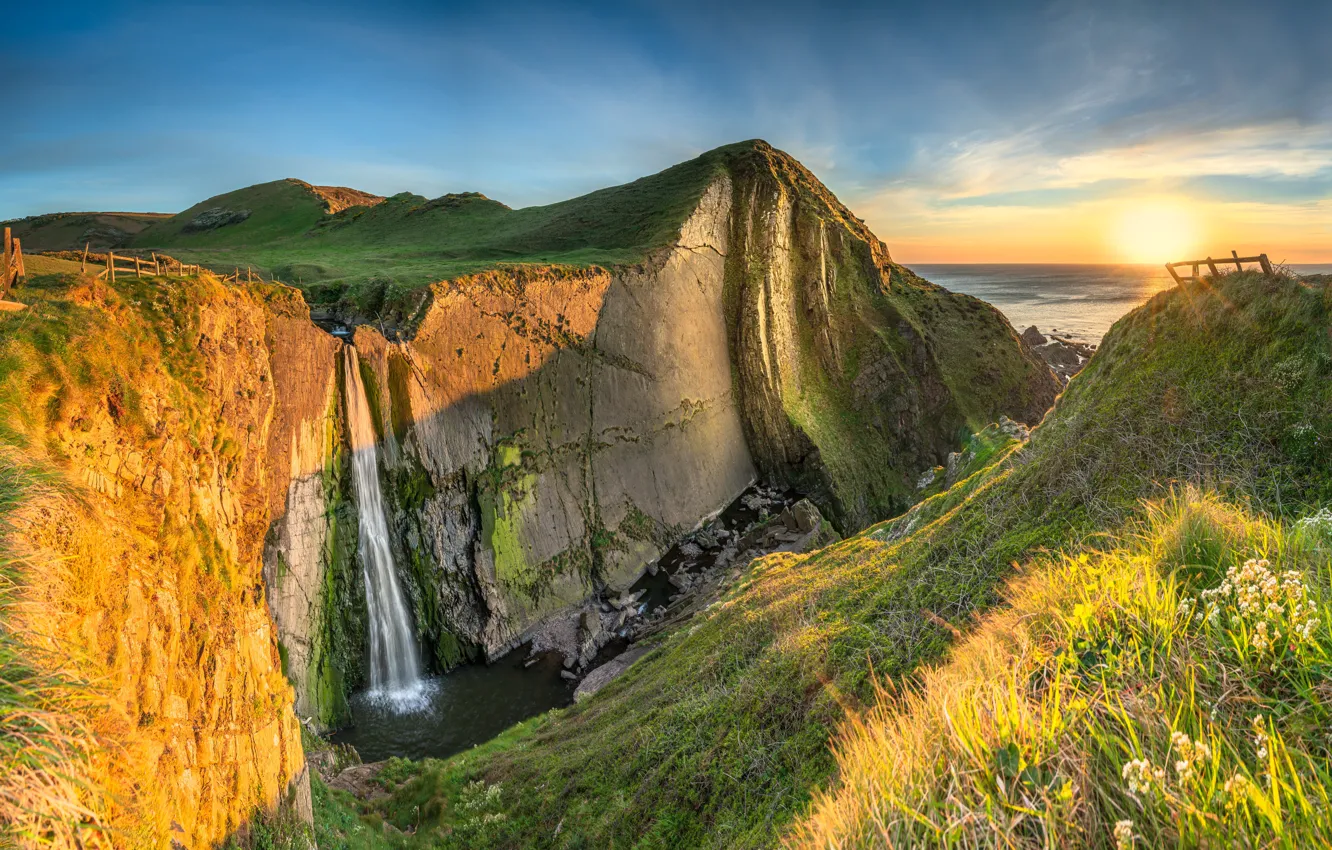 Photo wallpaper sea, the sky, the sun, rocks, coast, waterfall, horizon, Devon
