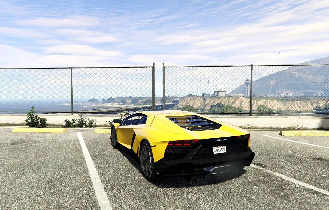 Photo wallpaper the sky, asphalt, yellow, the fence, Lamborghini, back, Parking, Aventador