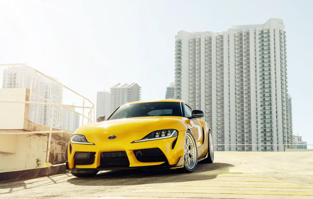 Photo wallpaper yellow, building, sports car, front view, Toyota Supra, 2020 Toyota GR Above