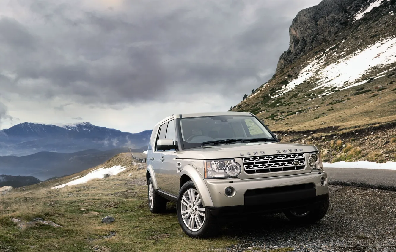 Photo wallpaper road, grass, clouds, snow, stones, cars, land rover, mountains