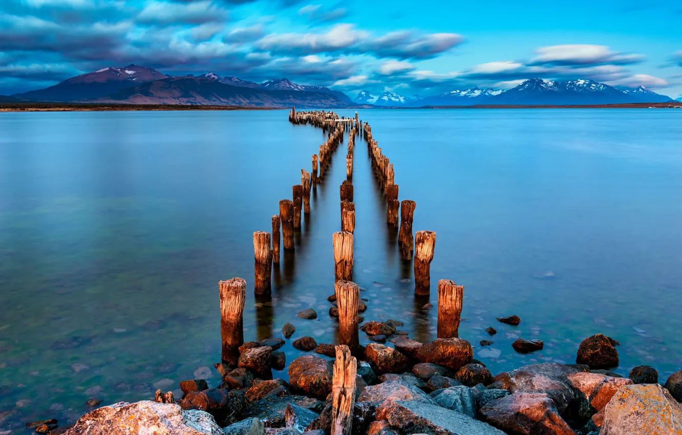 Photo wallpaper the sky, clouds, mountains, lake, stones, blue, posts, the bottom