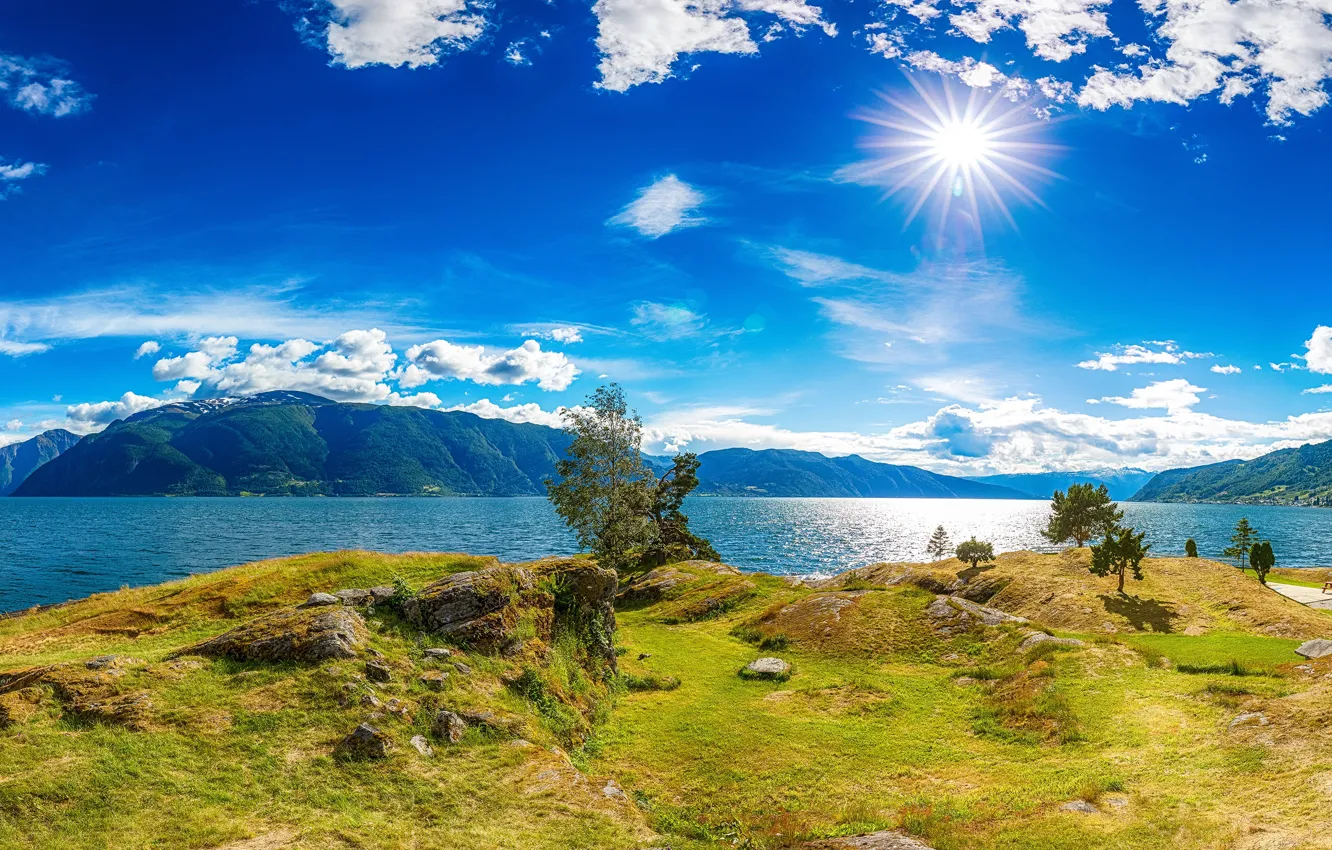 Photo wallpaper the sky, grass, the sun, clouds, rays, trees, mountains, stones