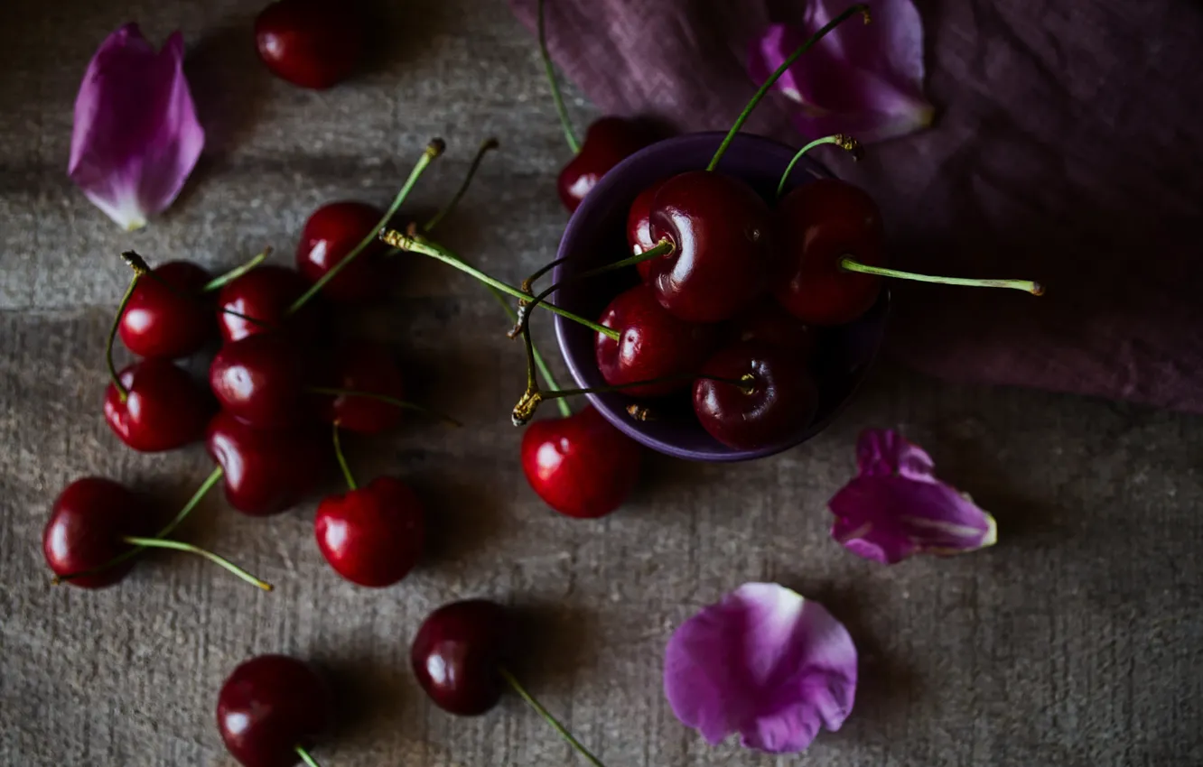 Photo wallpaper cherry, berries, the dark background, table, petals, fabric, pink, bowl