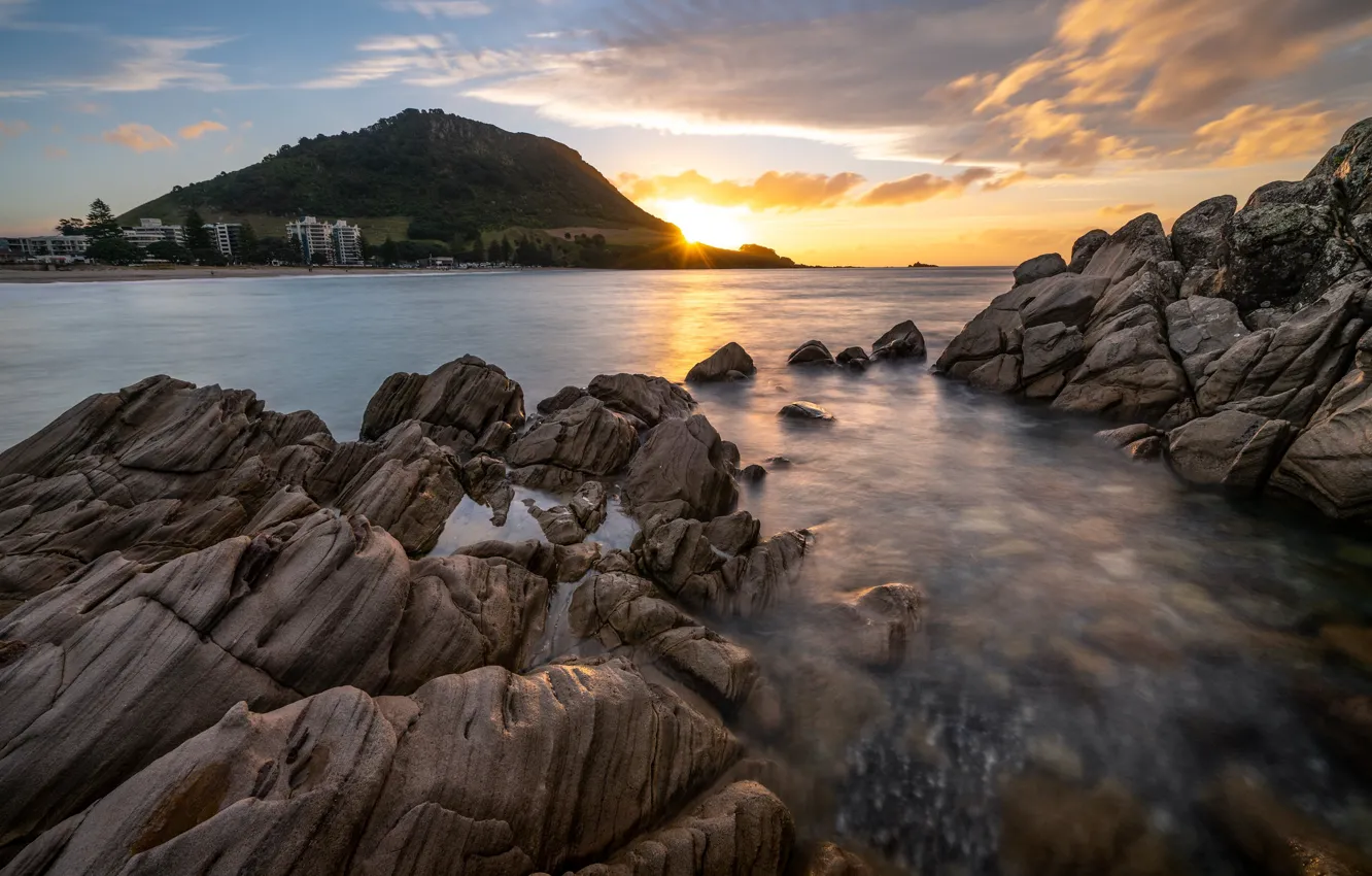 Photo wallpaper sea, the sky, the sun, clouds, sunset, the city, stones, rocks