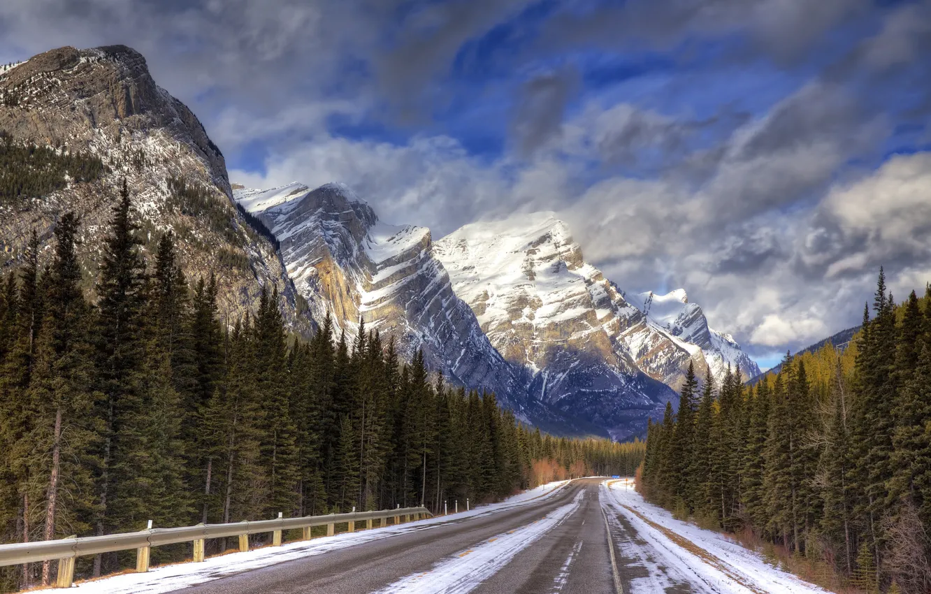 Photo wallpaper road, forest, the sky, clouds, snow, mountains, highway