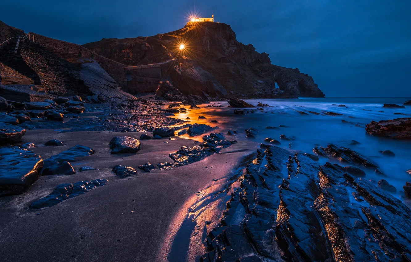 Photo wallpaper sea, night, lights, stones, rocks, coast