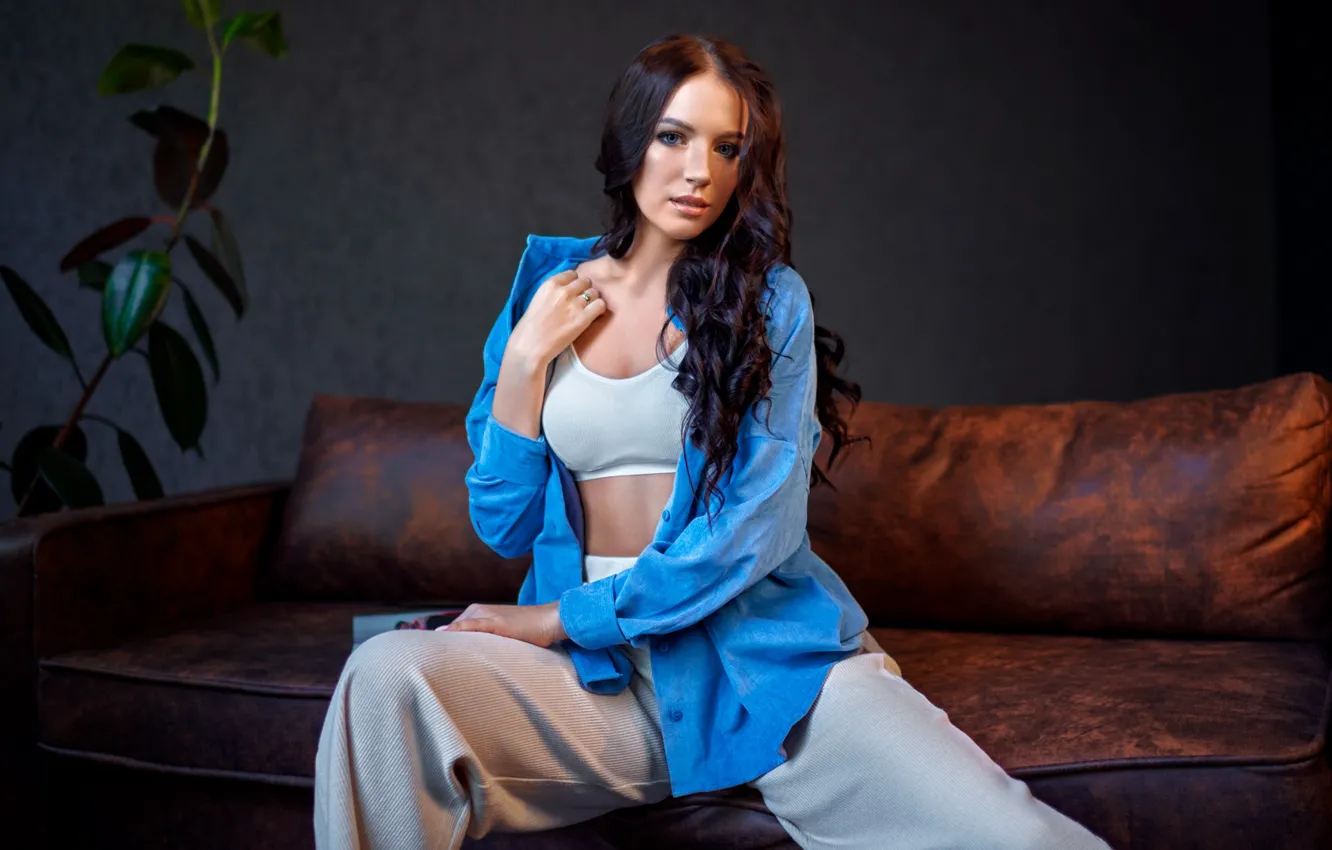 Photo wallpaper girl, pose, sofa, brunette, blouse, top, curls, pants