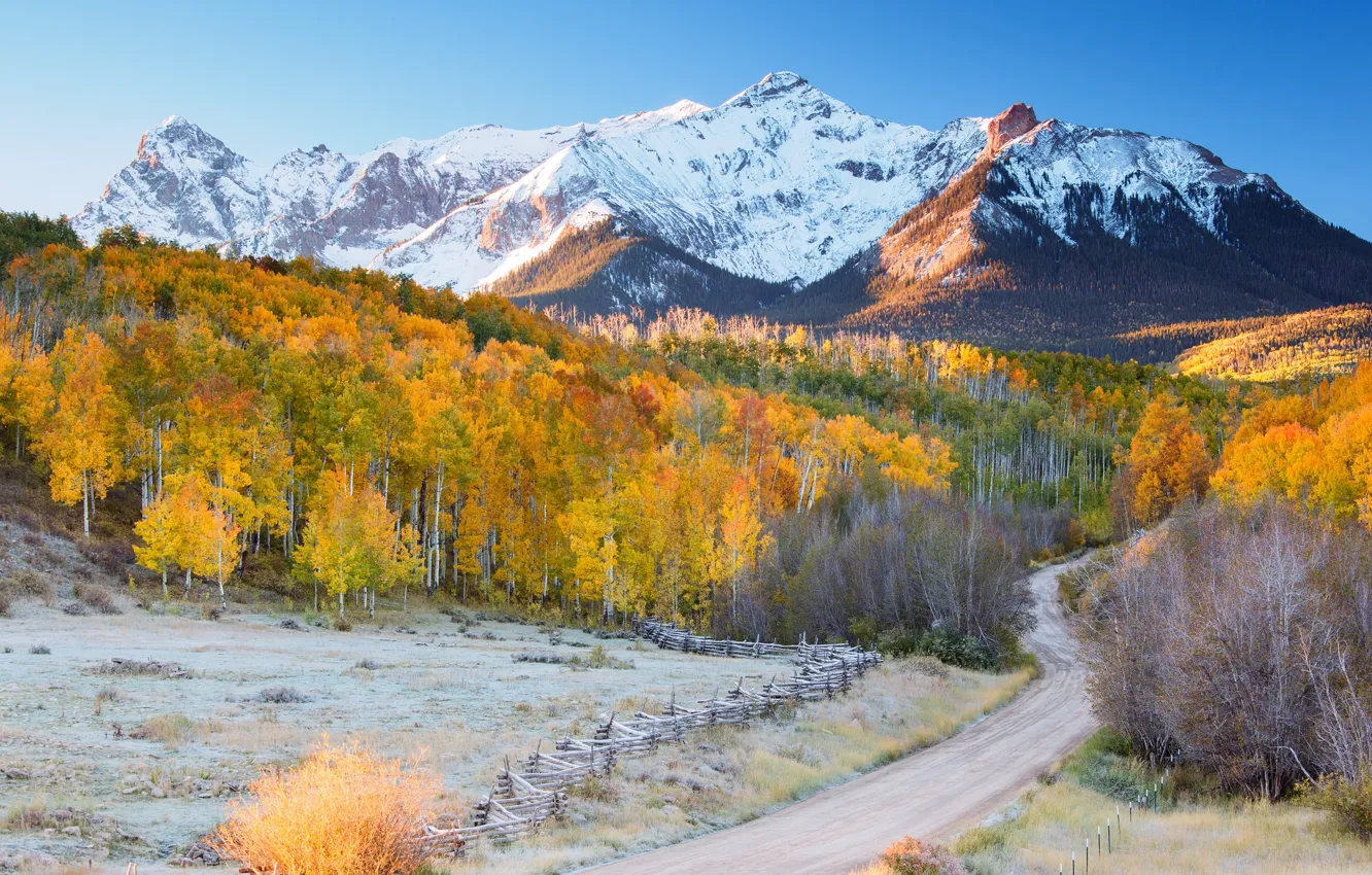 Photo wallpaper road, autumn, forest, mountains, snowy peaks
