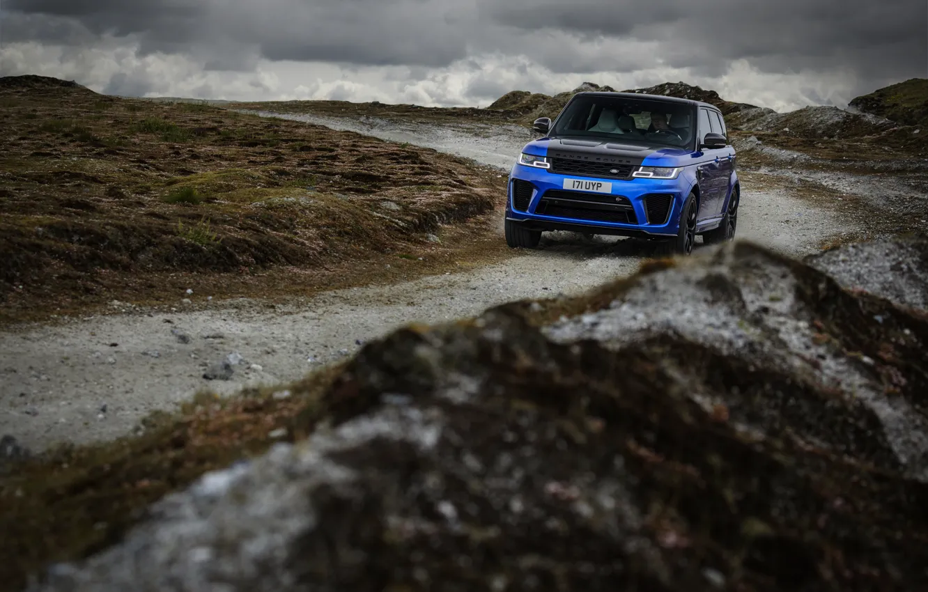Photo wallpaper road, blue, clouds, overcast, hills, vegetation, SUV, Land Rover