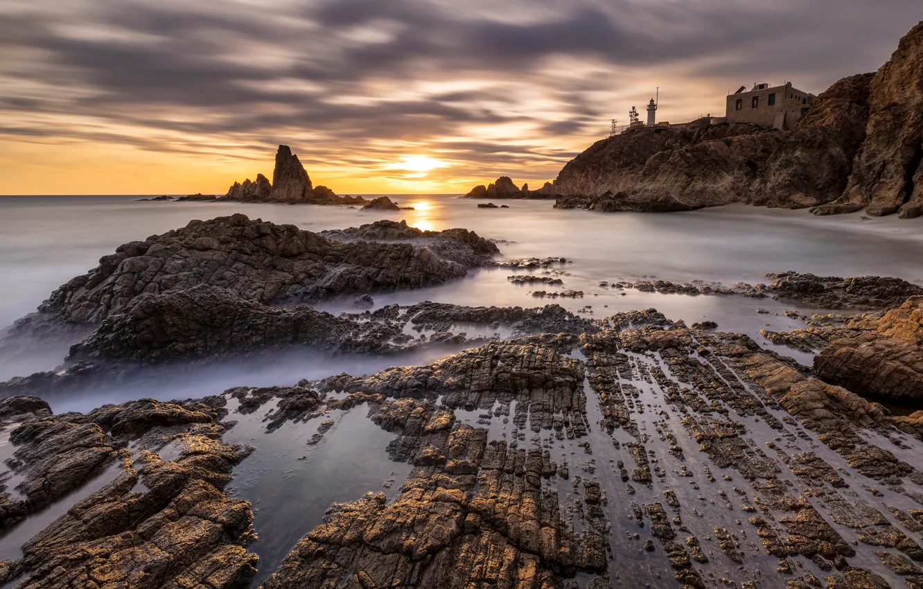 Photo wallpaper sea, the sky, clouds, sunset, house, stones, rocks, shore