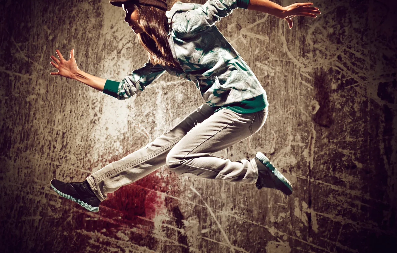 Photo wallpaper girl, pose, wall, jump, sneakers, dance, jeans, hairstyle