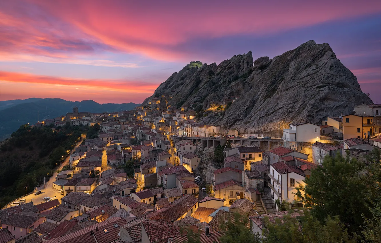 Photo wallpaper clouds, light, sunset, mountains, the city, lights, rocks, building