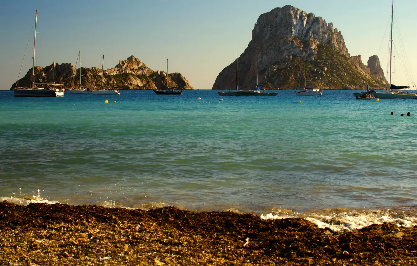 Photo wallpaper yacht, shore, the sun, Spain, rocks, Ibiza, sea