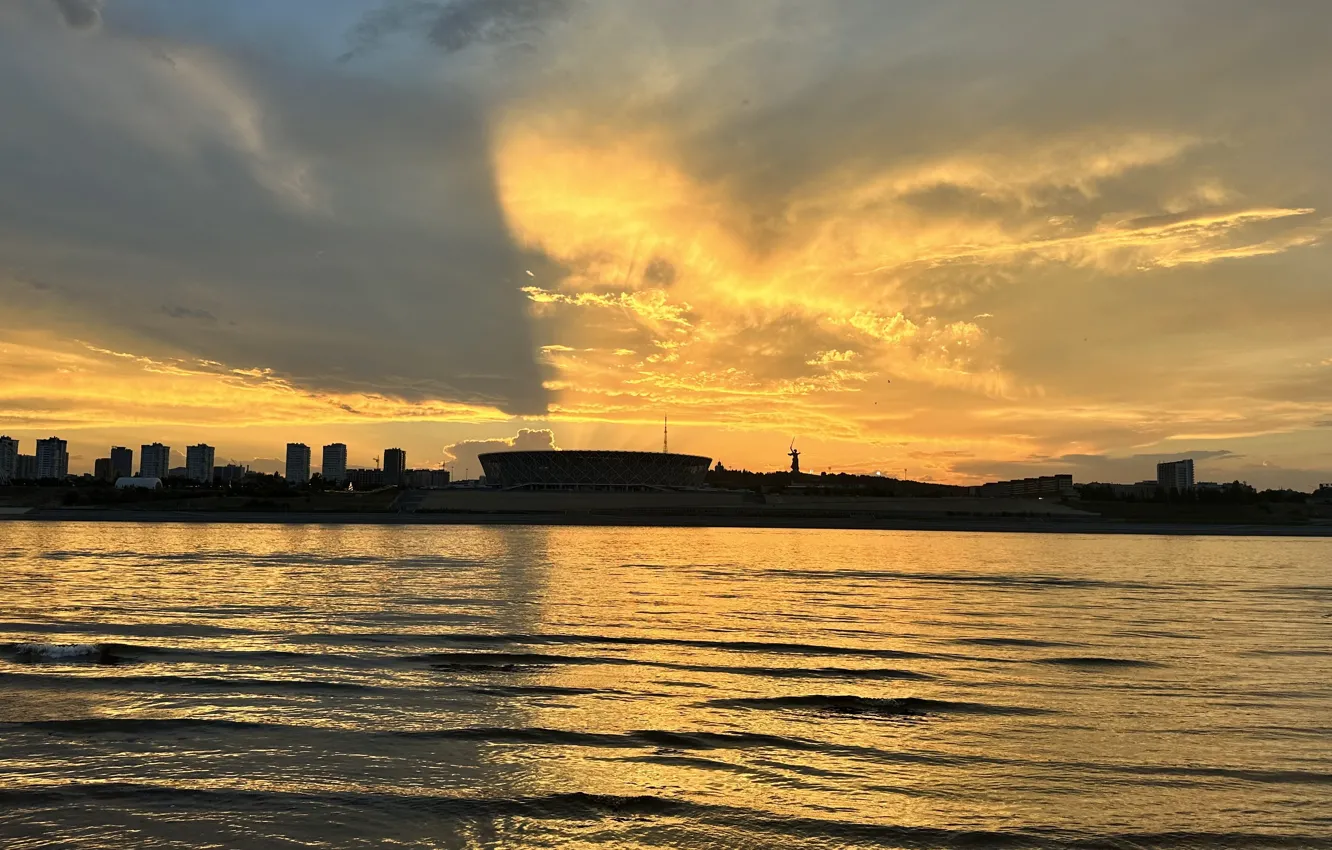 Photo wallpaper wave, clouds, rays, sunset, the city