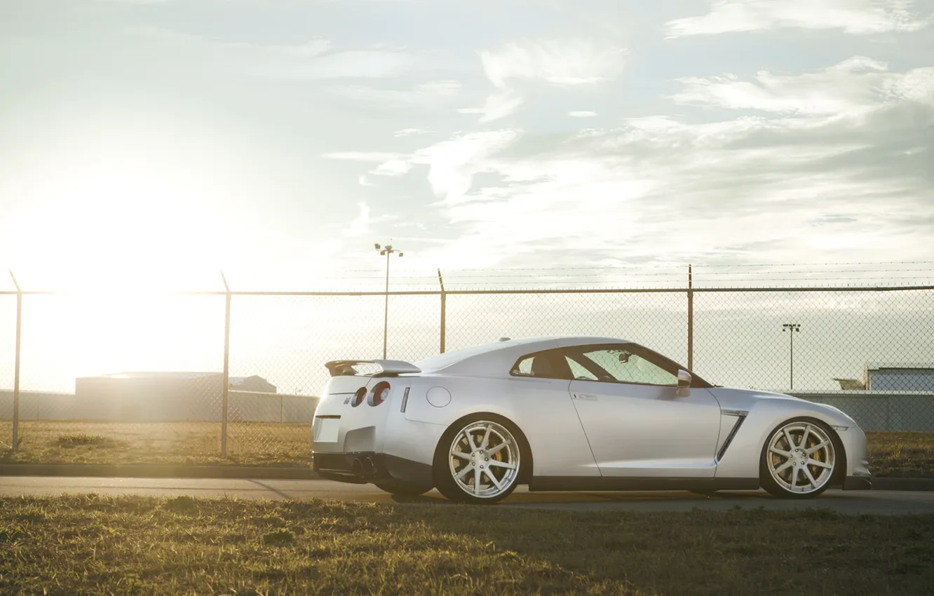 Photo wallpaper grass, the sun, sunset, the fence, GTR, Nissan