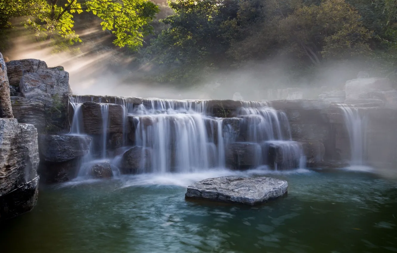 Photo wallpaper rays, light, branches, fog, stones, rocks, shore, waterfall
