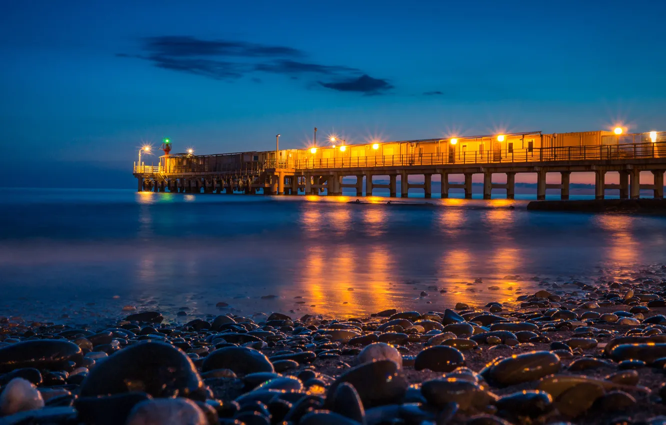Photo wallpaper sea, night, lights, stones, coast, horizon, lights, pierce