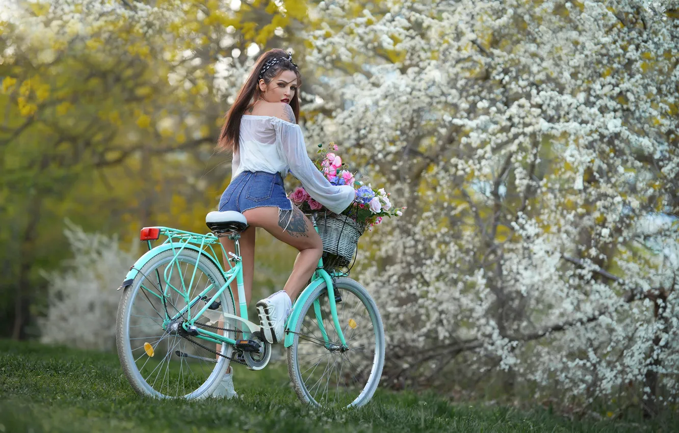 Photo wallpaper girl, trees, flowers, bike, pose, basket, shorts, garden