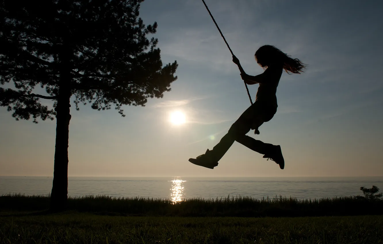 Photo wallpaper sea, the sky, grass, girl, the sun, trees, swing, shore