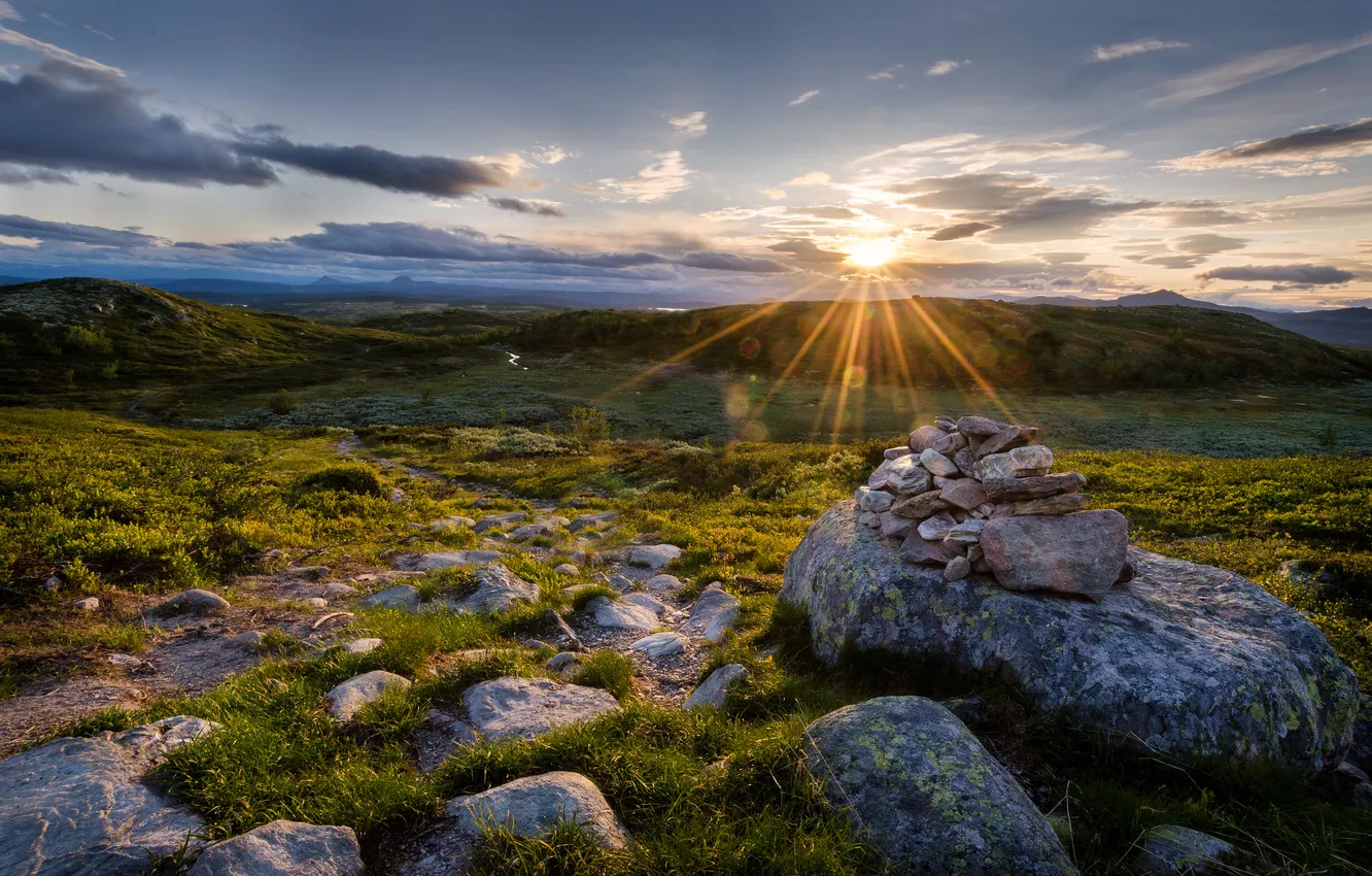 Photo wallpaper grass, the sun, sunset, stones, hills