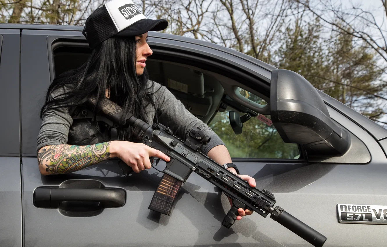 Photo wallpaper girl, face, hair, hands, tattoo, cap, car, assault rifle