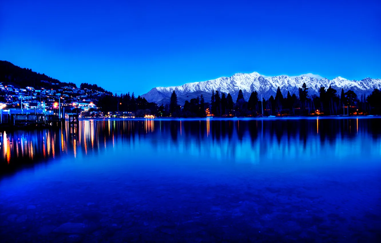 Photo wallpaper mountains, the city, lights, lake, reflection, pine, twilight