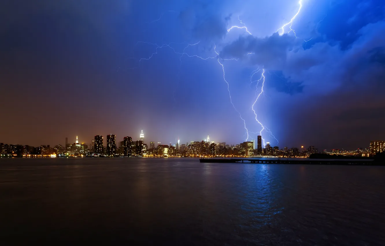 Photo wallpaper the storm, water, clouds, night, the city, lights, the ocean, lightning