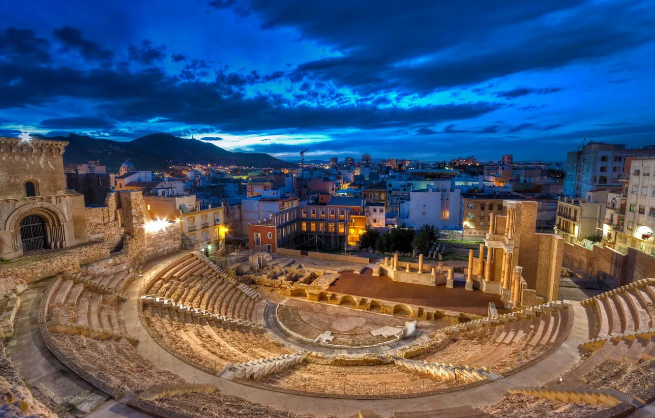 Photo wallpaper clouds, night, lights, home, ruins, Spain, Cartagena, Roman theatre