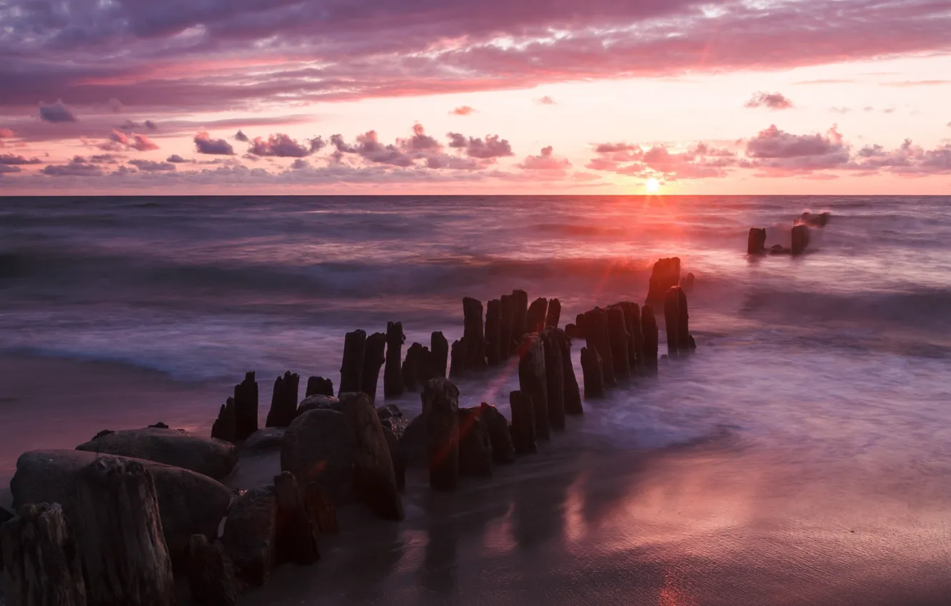 Photo wallpaper sunset, stones, the ocean, shore, posts, pierce, pink
