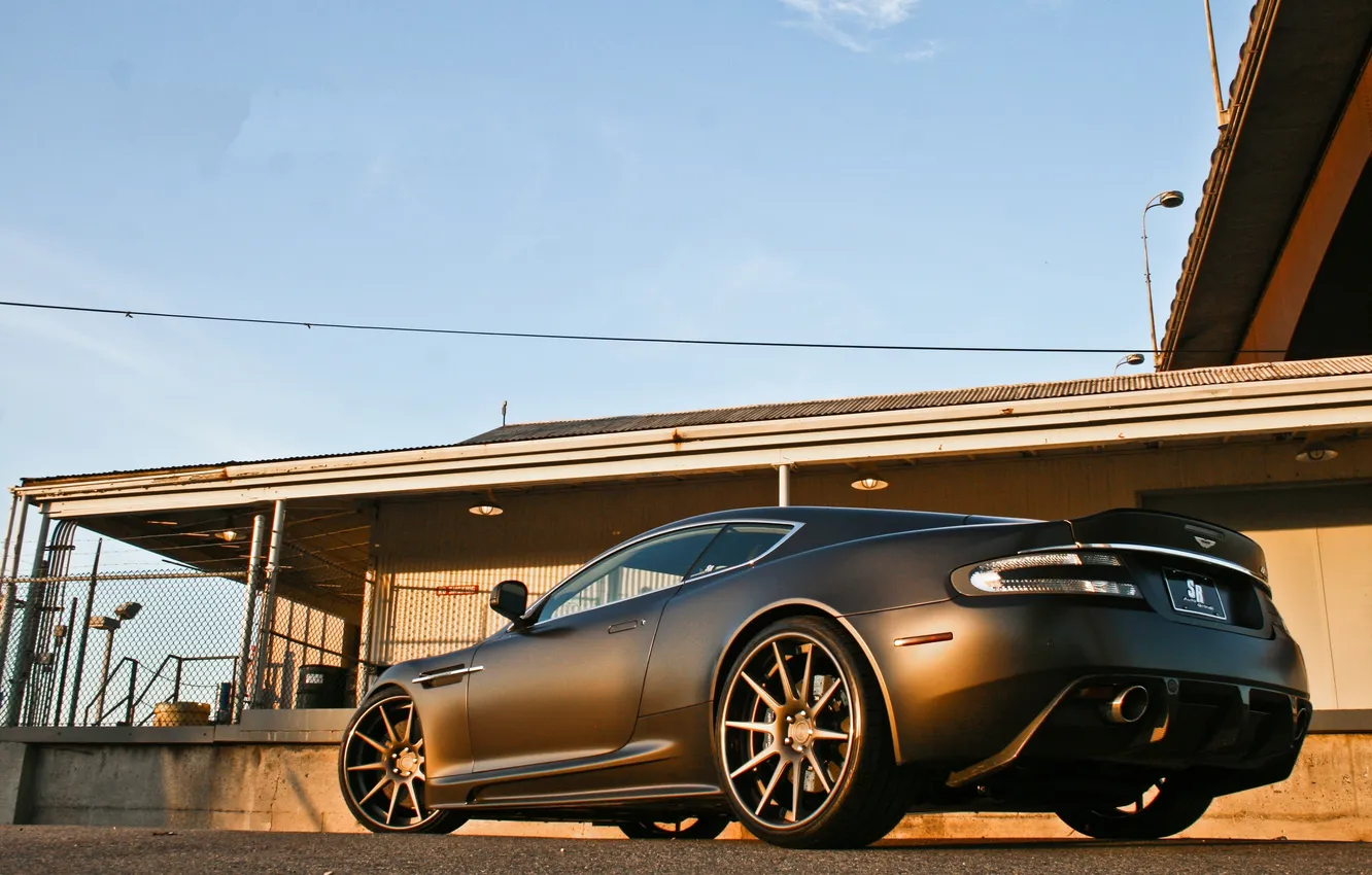 Photo wallpaper Aston Martin, black, building, DBS, Matt, the fence, Aston Martin, rear view
