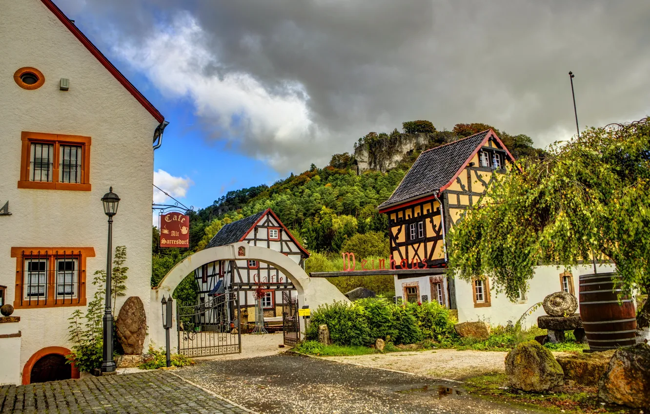 Photo wallpaper the sky, clouds, the city, the fence, gate, Germany, cafe, houses