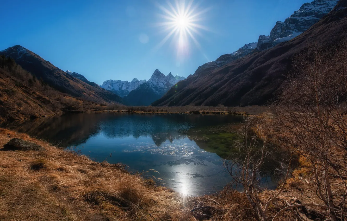 Photo wallpaper autumn, the sun, rays, light, trees, mountains, branches, lake