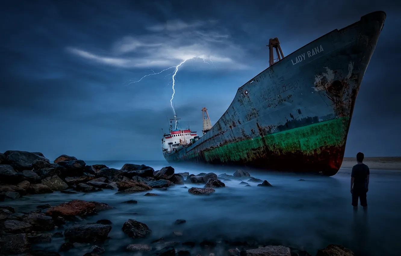 Photo wallpaper sea, stones, lightning, people, ship, stranded