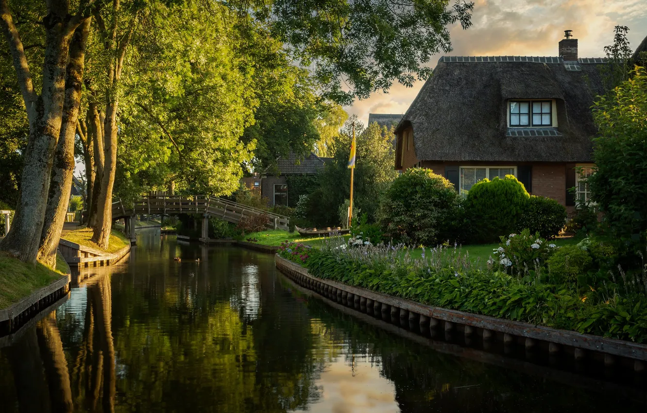 Photo wallpaper home, flowers, reflection, shore, channel, house, branches, the bridge