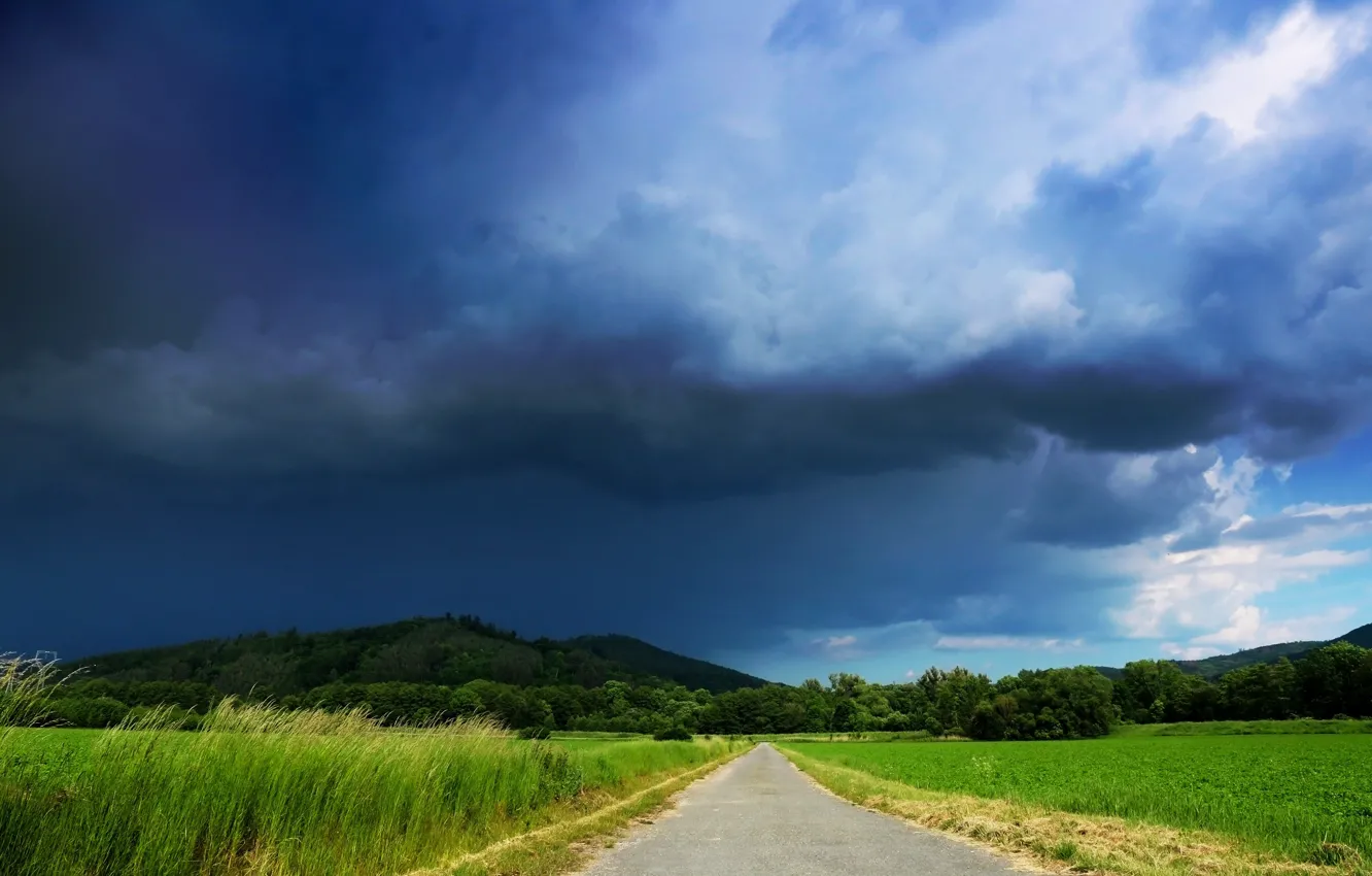 Photo wallpaper road, the storm, field, forest, the sky, grass, clouds, hills