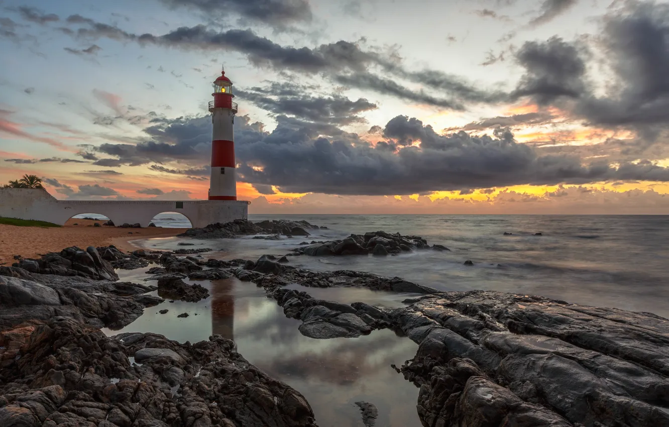 Photo wallpaper sea, wave, clouds, light, sunrise, stones, lighthouse, horizon
