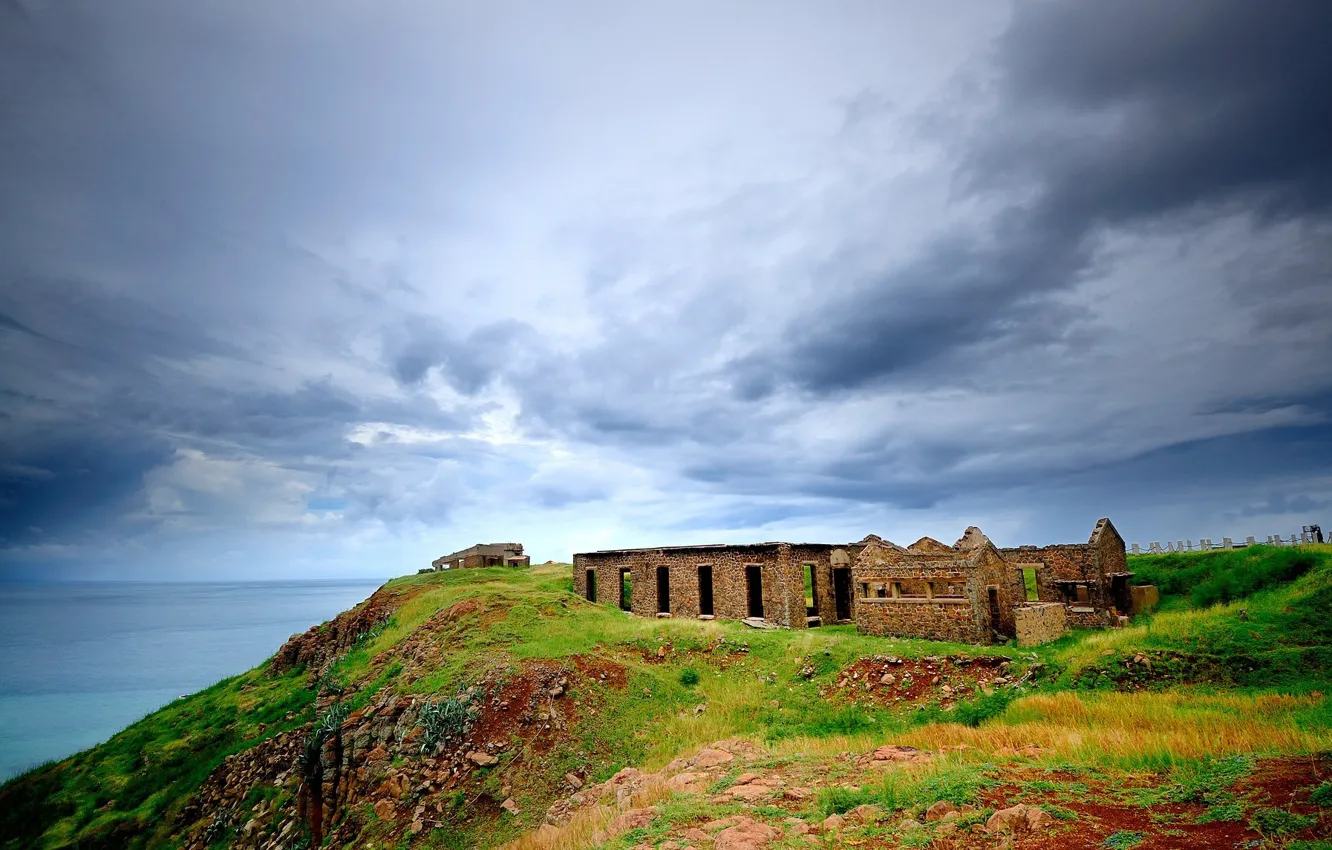 Photo wallpaper sea, grass, hills, home, ruins, buildings