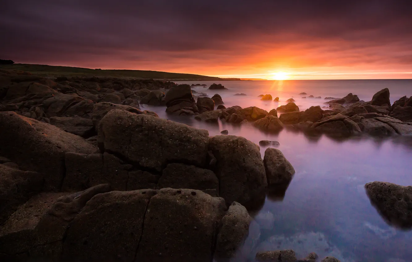 Photo wallpaper sea, the sun, clouds, rays, light, sunset, stones, rocks
