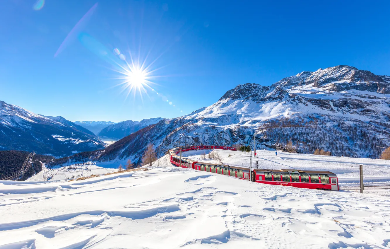 Photo wallpaper winter, the sky, the sun, rays, snow, trees, mountains, train