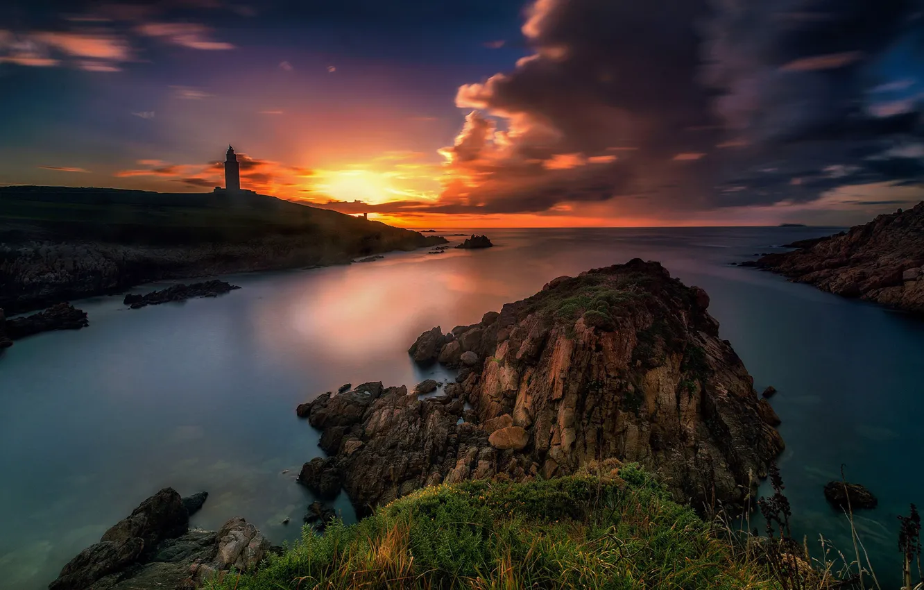Photo wallpaper sea, clouds, sunset, stones, rocks, shore, lighthouse, bright colors