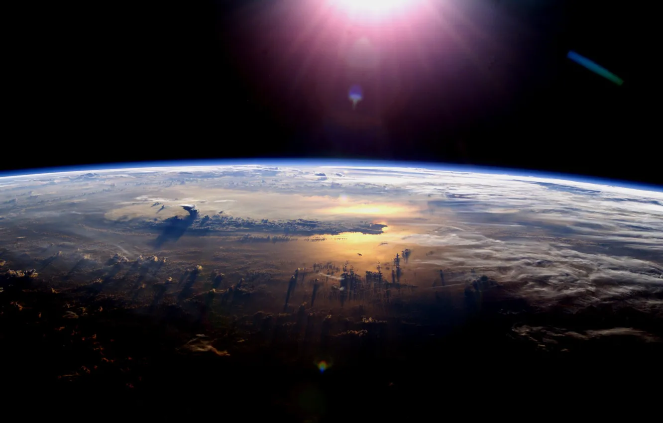 Photo wallpaper space, clouds, light, planet, the atmosphere