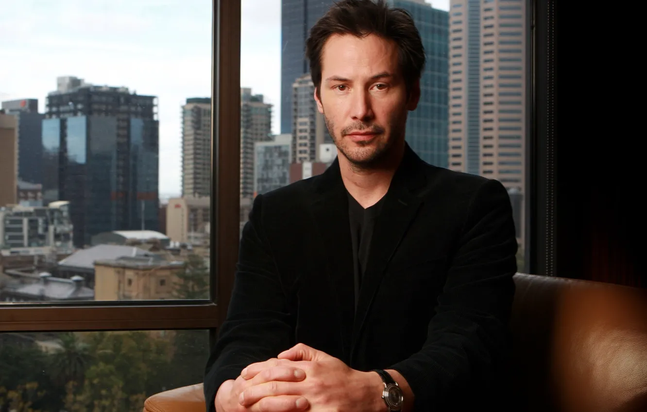 Photo wallpaper the city, view, chair, window, actor, sitting, Keanu Reeves, Keanu Reeves