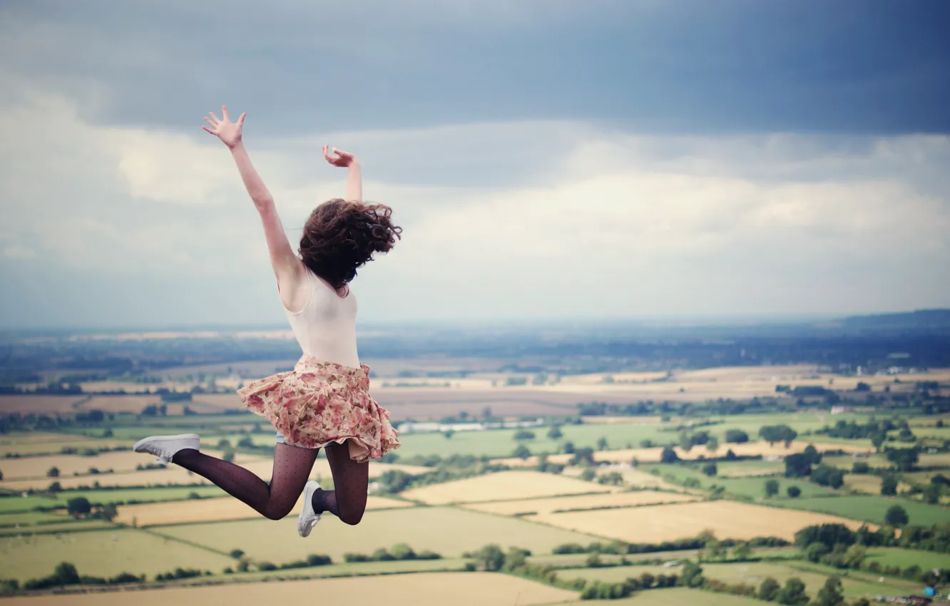 Photo wallpaper field, the sky, girl, clouds, flight, jump, hair, skirt