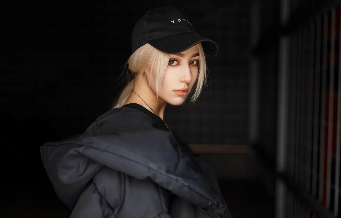 Photo wallpaper girl, beauty, hair, look, blonde, dark background, baseball cap, feather jacket