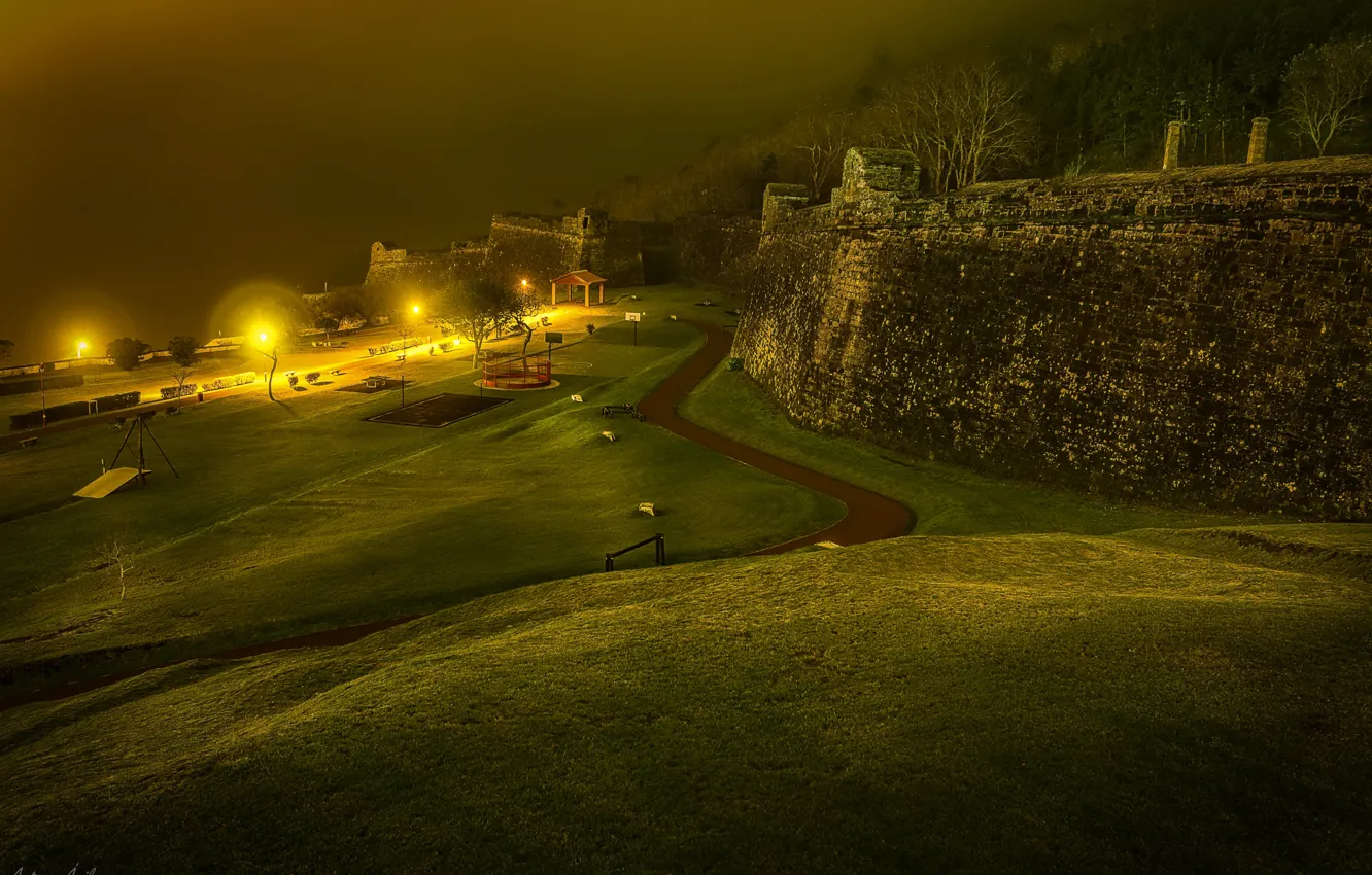 Photo wallpaper road, night, lights, fog, lawn, wall, lights, fortress