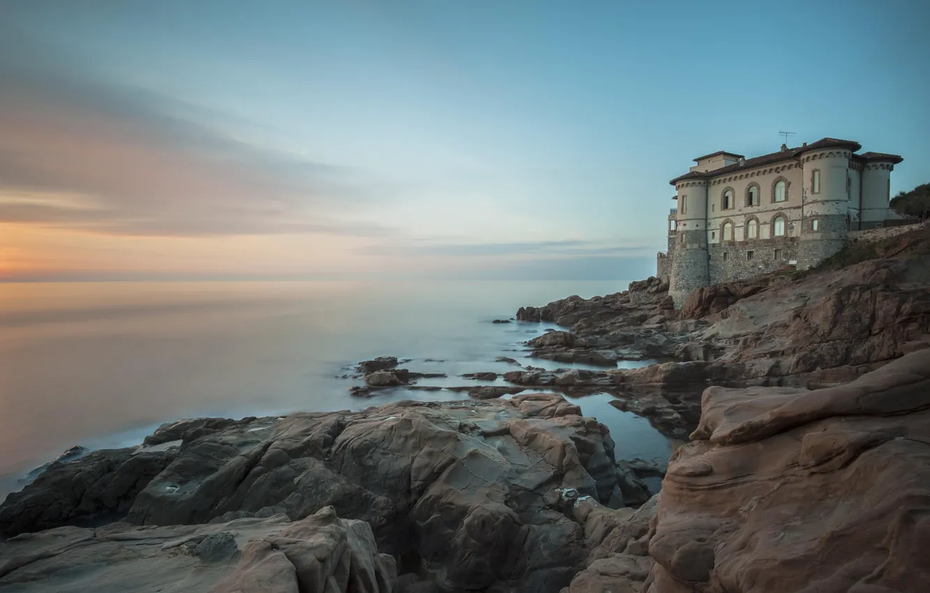 Photo wallpaper sea, sunset, stones, shore, building