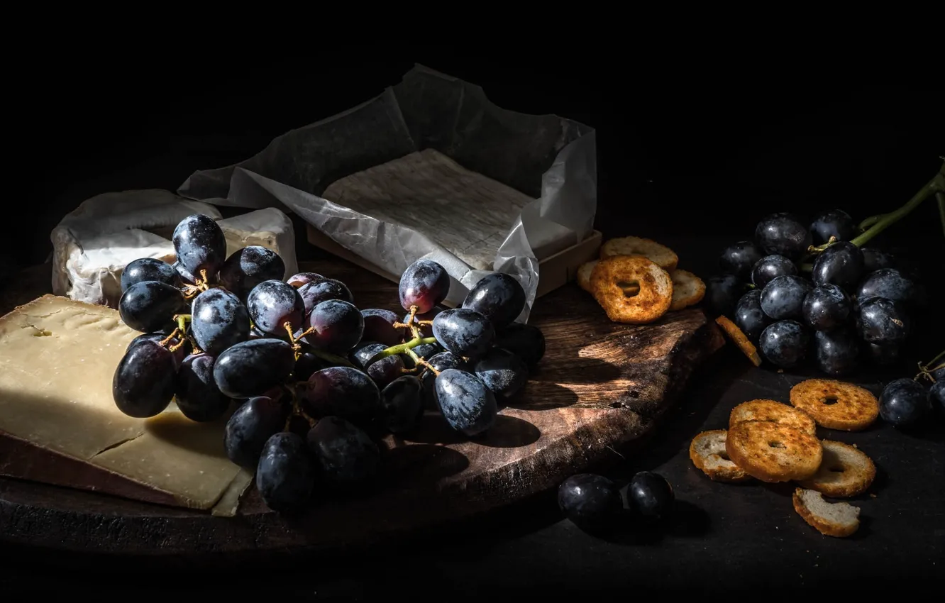Photo wallpaper light, paper, the dark background, table, shadow, cheese, grapes, still life
