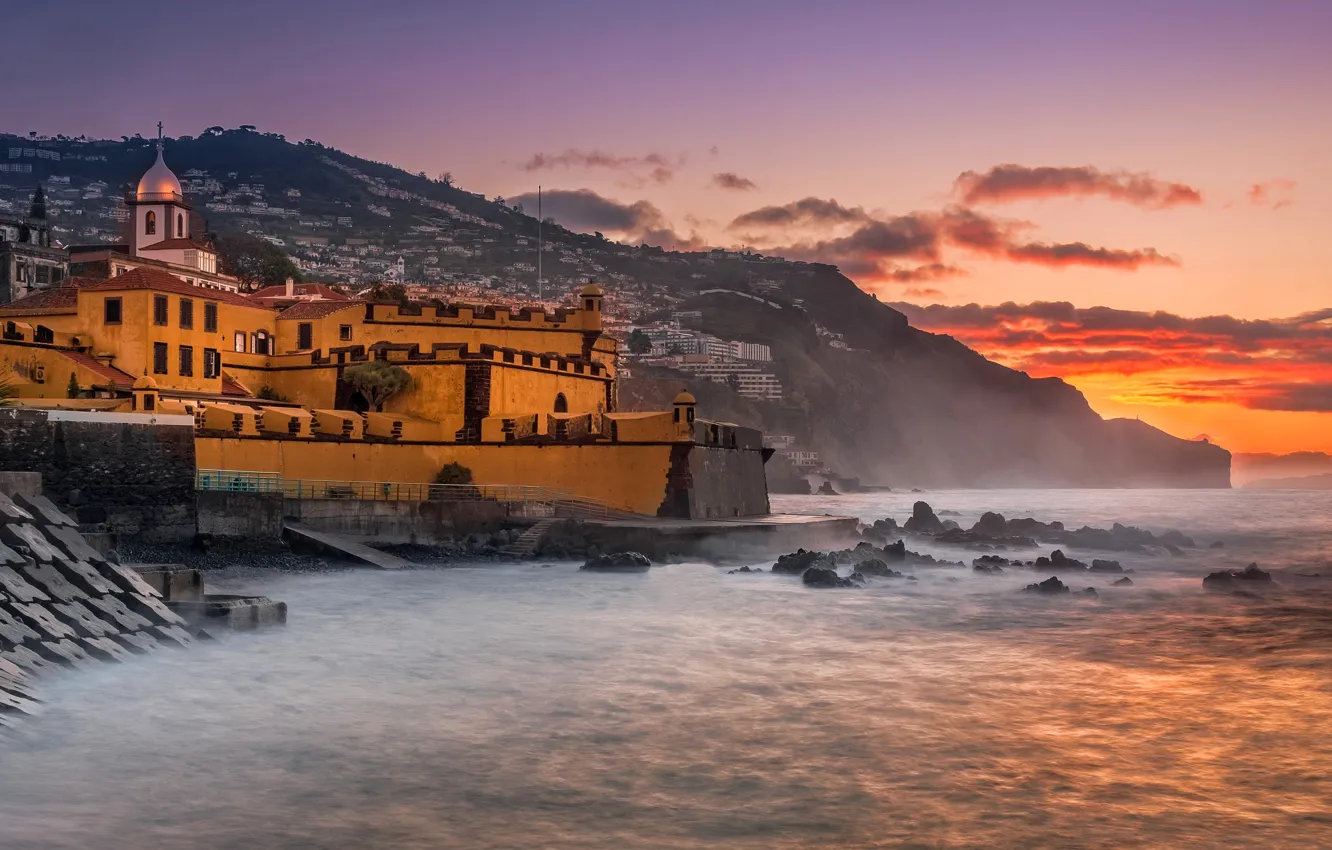 Photo wallpaper sea, sunset, mountains, stones, shore, Portugal, architecture, Madeira