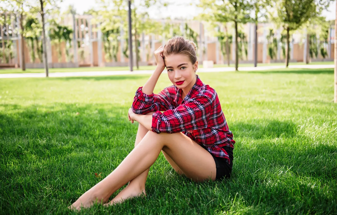 Photo wallpaper grass, look, girl, smile, shorts, shirt, legs, sitting