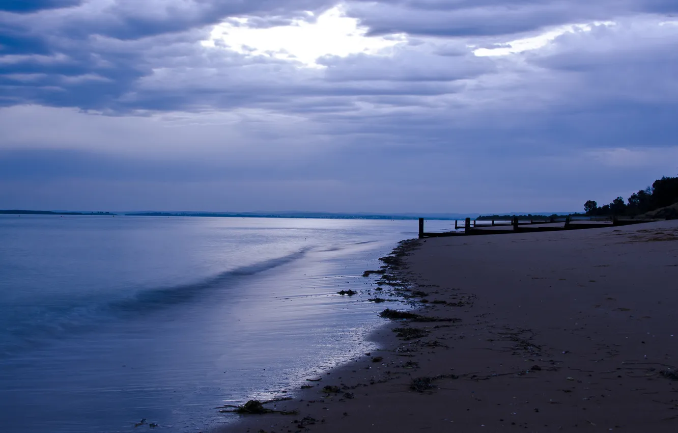 Photo wallpaper sand, sea, clouds, posts, twilight
